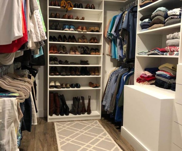 walk in closet with shoe shelf and clothes